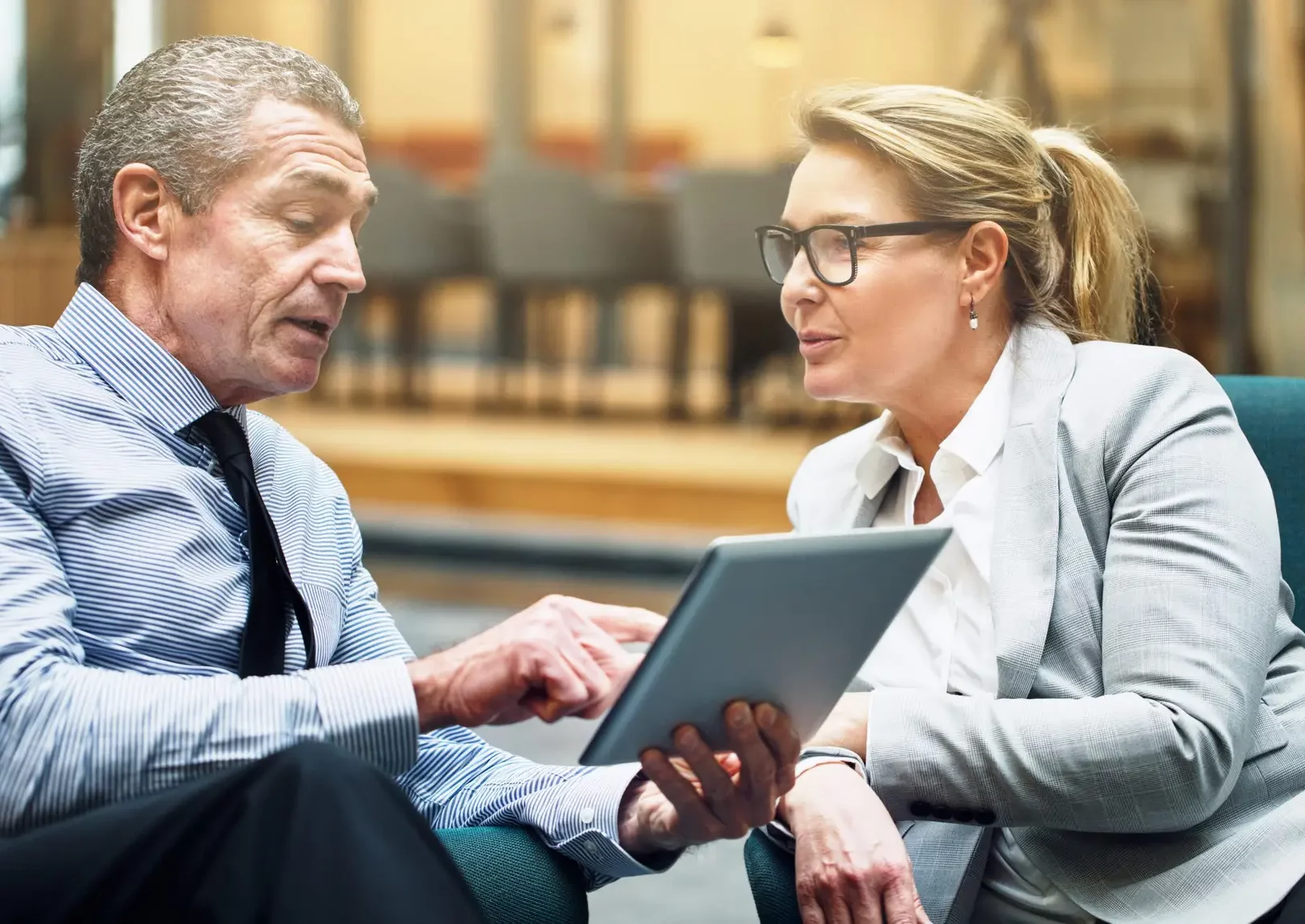 A coach and a client sit together discussing coaching specialties